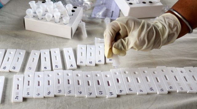 A health worker takes prepares rapid antigen tests to detect Covid-19. (Express Photo/File)