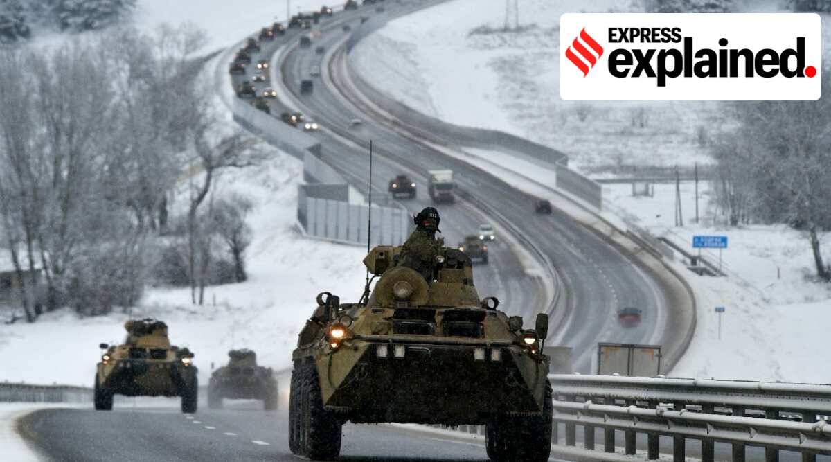 A convoy of Russian armored vehicles moves along a highway in Crimea, Tuesday, Jan. 18, 2022. (AP Photo)