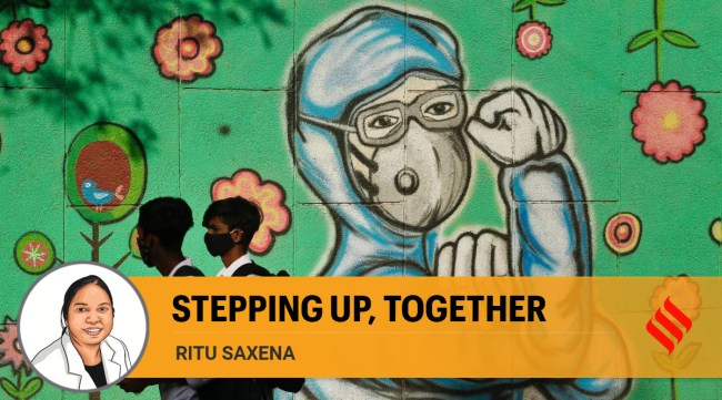 School students pass graffiti of doctors during the Covid-19 pandemic in New Delhi. (Express Photo: Praveen Khanna)