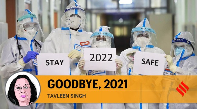 Medical staff of M S Ramaiah hospital wearing PPE and gloves hold placards with a message on New Year's eve amid concern over rising Omicron cases, in Bengaluru. (PTI)
