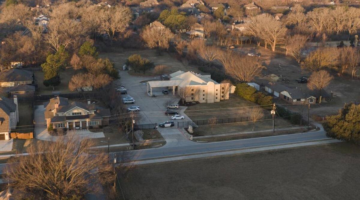 An aerial view of police standing in front of the Congregation Beth Israel synagogue, Sunday, Jan 16, 2022, in Colleyville, Texas. (AP)