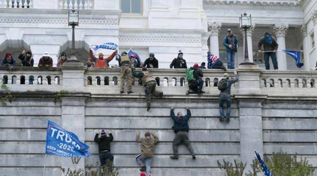Rioters seen climbing the US Capitol Hill during the January siege this year. (AP Photo)