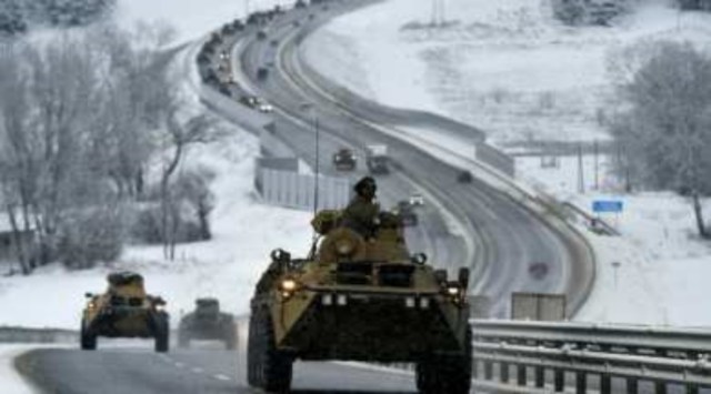 A convoy of Russian armored vehicles moves along a highway in Crimea, Tuesday, Jan. 18, 2022. (AP)