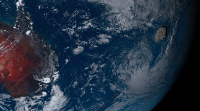 This satellite image taken by Himawari-8, a Japanese weather satellite operated by Japan Meteorological Agency and released by National Institute of Information and Communications Technology (NICT), shows an undersea volcano eruption, right, at the Pacific nation of Tonga Saturday, Jan. 15, 2022. (NICT via AP)