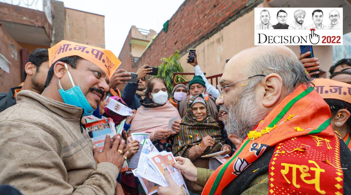 Union Home Minister Amit Shah interacts with a resident during his door-to-door campaign ahead of Uttar Pradesh Assembly elections, in Kairana. (PTI Photo)