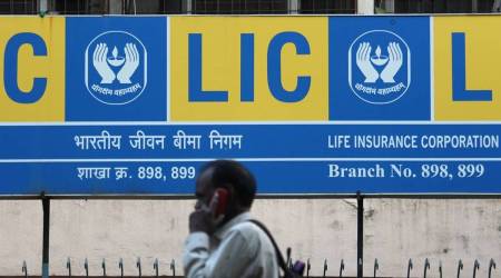 A man talks on a mobile phone outside the Life Insurance Corporation of India (LIC) branch in Mumbai. (Bloomberg)
