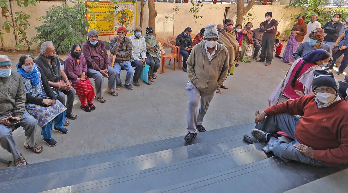 A queue in Ahmedabad as ‘precautionary’ doses for 60-plus began Monday. Around 9.68 lakh are believed to have received the shots on the first day. (Express photo by Nirmal Harindran)