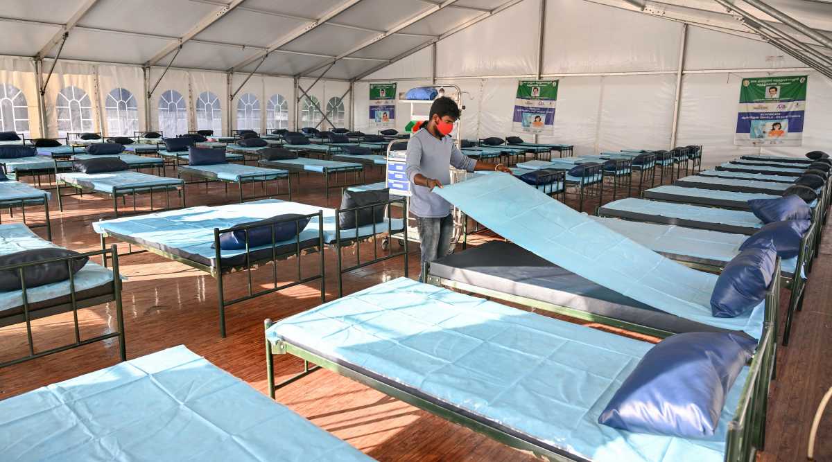A health worker arranges beds at Omandurar Super Speciality hospital as part of preparations for the expected third wave of COVID-19, in Chennai, Thursday, Jan. 6, 2022. (PTI Photo)