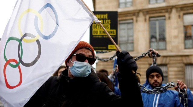  A man holds the Olympic flag during an action by Amnesty International activists to protest against human rights violations in China before the Beijing 2022 Winter Olympics, in front of the National Assembly in Paris, France, January 26, 2022. (Reuters)