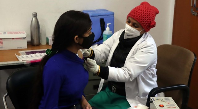 A Girl take the jab at COVID19 Vaccine at Vaccination centre at GMSH Sector 16 of Chandigarh on Thursday. Express Photo by Kamleshwar Singh 
