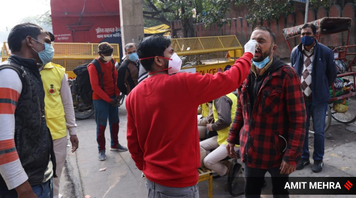 A healthworker collects a swab sample in New Delhi on Thursday. (Express Photo)