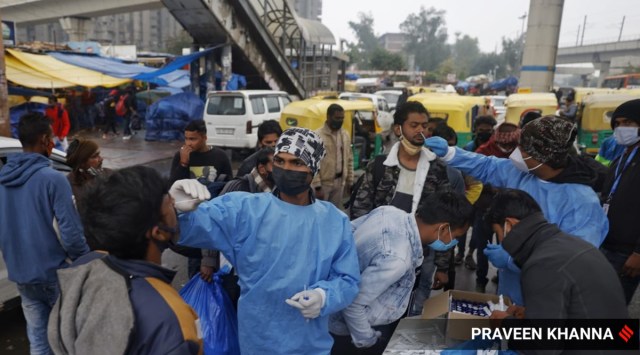 Covid testing on roadside during the weekend curfew in view of rising cases in New Delhi on Sunday. (Express Photo by Praveen Khanna)
