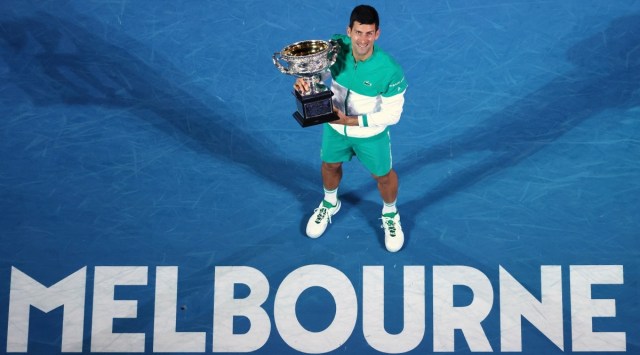 FILE - Serbia's Novak Djokovic holds the Norman Brookes Challenge Cup after defeating Russia's Daniil Medvedev in the men's singles final at the Australian Open tennis championship in Melbourne, Australia, Sunday, Feb. 21, 2021. Djokovic has had his visa canceled and been denied entry to Australia, Thursday, Jan. 6, 2022, and is set to be removed from the country after spending the night at the Melbourne airport as officials refused to let him enter the country for the Australian Open after an apparent visa mix-up.(AP Photo/Hamish Blair, File)


