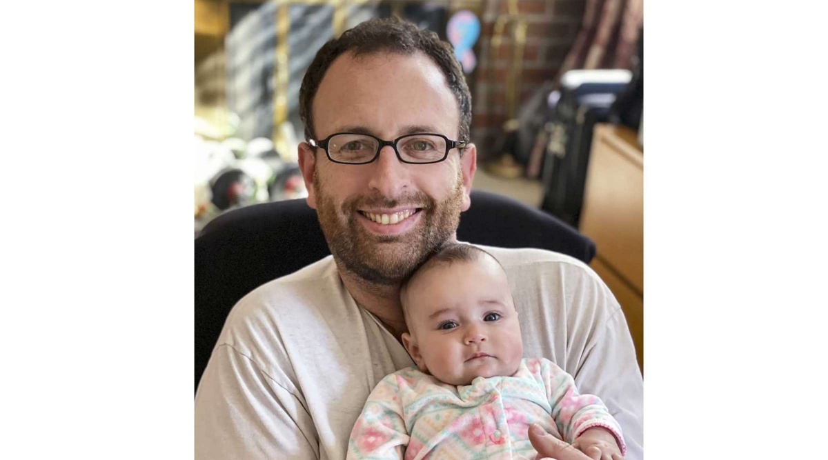 In this Oct. 2020 photo released by Eugene Brusilovskiy, Eugene holds his then-3-month-old daughter, Aya, in Philadelphia. Since Aya was born in the early months of the pandemic, Brusilovskiy was able to stay at home and spend time with her. (Eugene Brusilovskiy via AP)