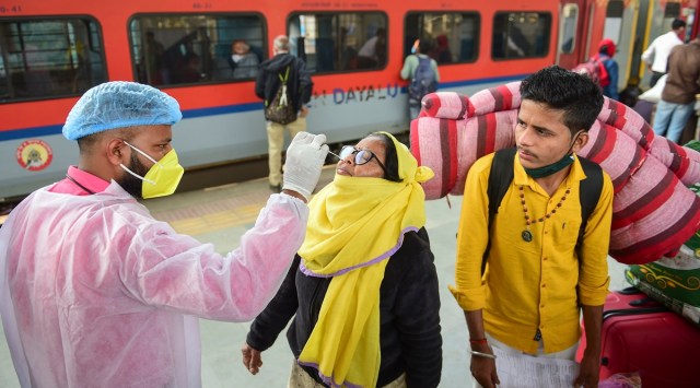 A BMC health worker collects swab sample of an outstation passenger for Covid-19 test, at Dadar railway station in Mumbai Jan 15, 2022. (PTI)