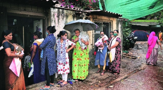 Outside a polio booth in Dharavi amid rain in Mumbai on Saturday morning. (Express Photo by Amit Chakravarty)