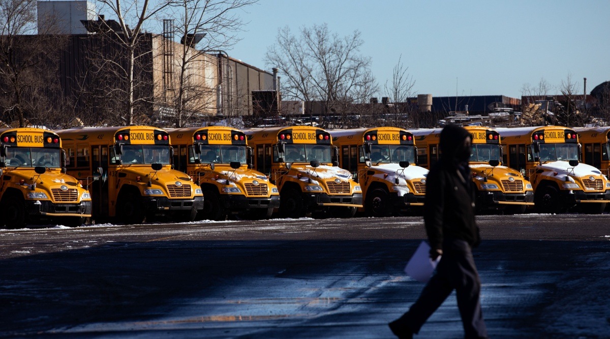Idled school buses in Detroit on Monday, Jan. 3, 2022. After a holiday break that saw Covid-19 case rates spike unrelentingly, a small but growing list of school districts have returned to remote learning. (Emily Elconin/The New York Times)