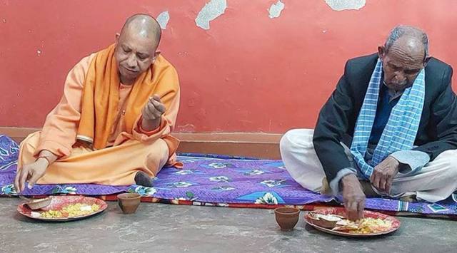 CM Yogi Adityanath has a meal at the house of party worker Amrit Lal Bharti, in Gorakhpur. (Courtesy: Twitter/Yogi Adityanath)