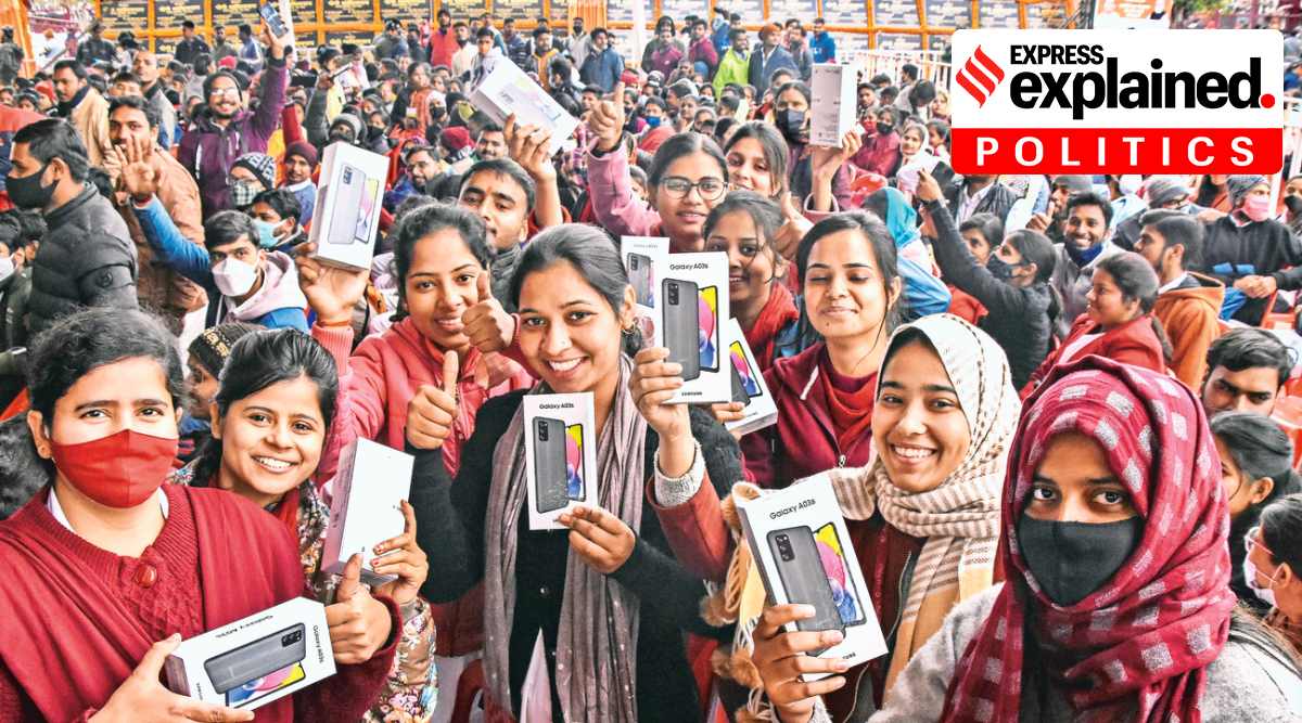 Students display the smartphones given to them by the BJP at a distribution event in Gorakhpur last week. (Source: PTI)