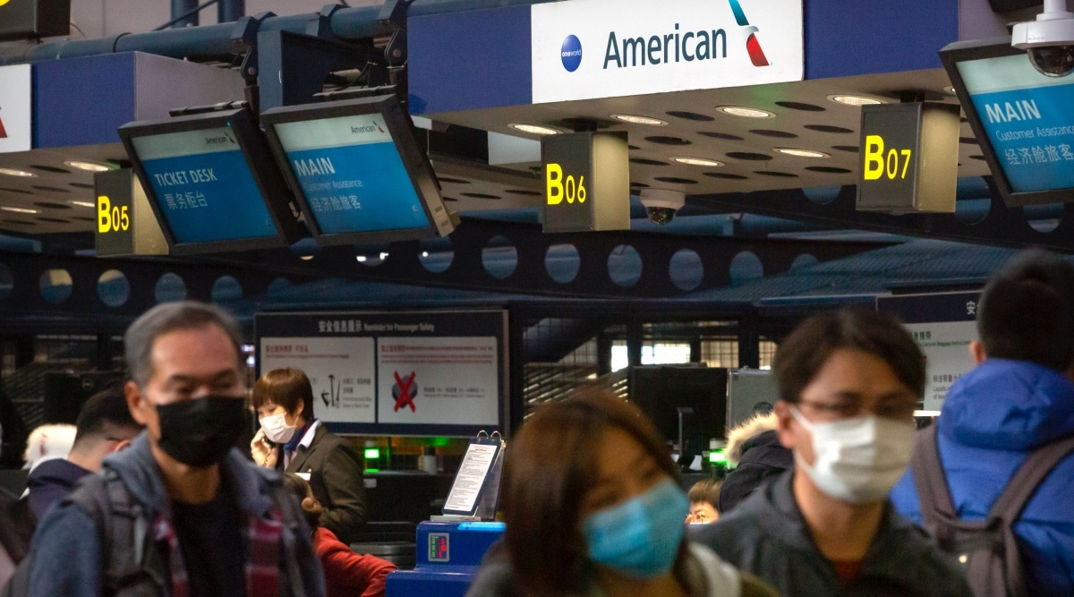 Travelers wearing face masks line up to check in for an American Airlines flight to Los Angeles at Beijing Capital International Airport in Beijing, Thursday, Jan. 30, 2020. (AP Photo/Mark Schiefelbein, File)


