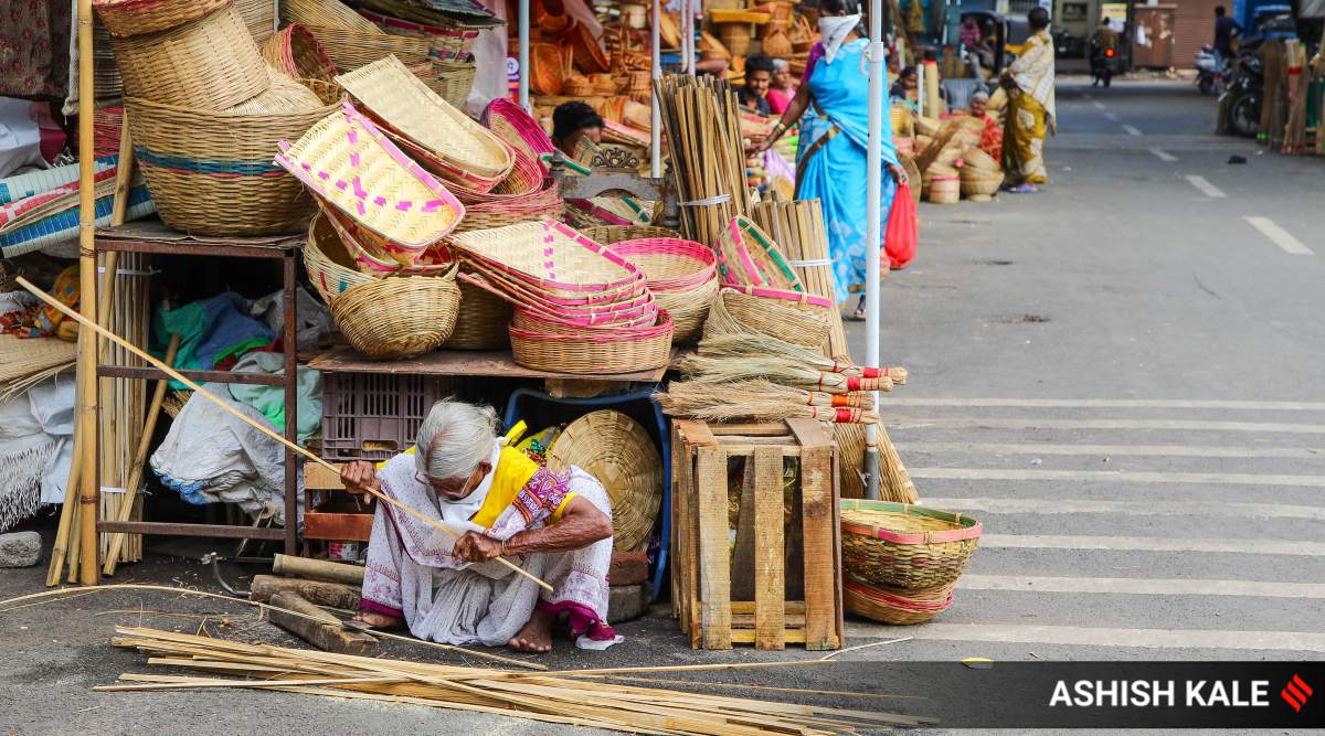 An elderly woman makes cane utensils at Mandai Market in Pune. (Express Photo: Ashish Kale)