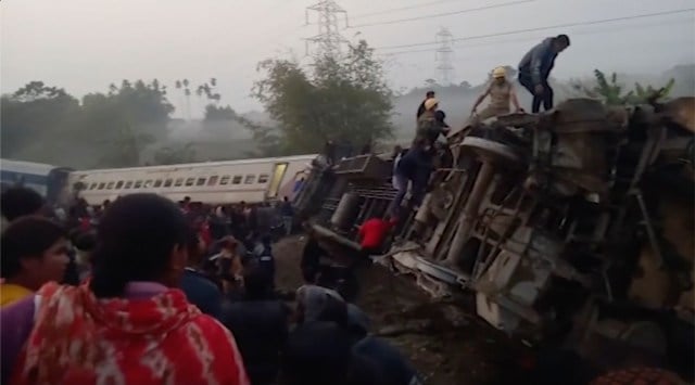 This image from video shows rescuers looking inside derailed coaches after a passenger train derailed in Jalpaiguri, West Bengal on Jan 13, 2022. (AP)