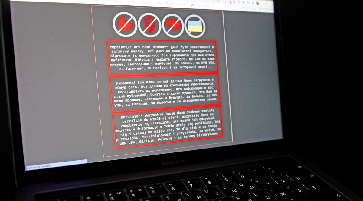 A laptop screen displays a warning message in Ukrainian, Russian and Polish, that appeared on the official website of the Ukrainian Foreign Ministry after a massive cyberattack, in this illustration taken January 14, 2022. REUTERS/Valentyn Ogirenko/Illustration