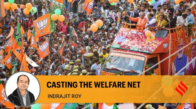 Uttar Pradesh Chief Minister Yogi Adityanath flashes the victory sign during a roadshow for the ongoing UP Assembly elections, in Prayagraj, Friday, Feb. 25, 2022. (PTI Photo)