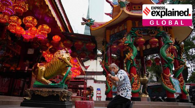 An ethnic Chinese worshiper wearing a face mask prays to celebrate the Lunar New Year at a temple in Jakarta, Indonesia, Monday, Jan. 31, 2022. (AP Photo/Achmad Ibrahim)