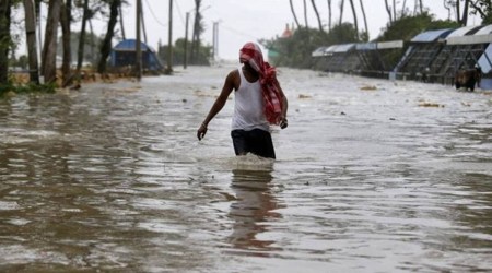 A man wades through a water-logged road after rains ahead of Cyclone Yaas at Digha in Purba Medinipur district in the eastern state of West Bengal, India, May 26, 2021. (REUTERS)