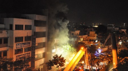 Fire officials carried out rescue 20 children from library hall on the top floor of a commercial complex at Dabholi in Surat city, on Wednesday evening. (Express Photo by Hanif Malek)