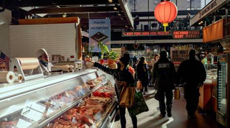 A woman shops for meat at the Essex Market on Manhattan's Lower East Side on Tuesday, Feb. 9, 2022. High inflation has been a political liability for the White House, as rising prices have eaten away at household paychecks, leaving consumers feeling pessimistic. (The New York Times)