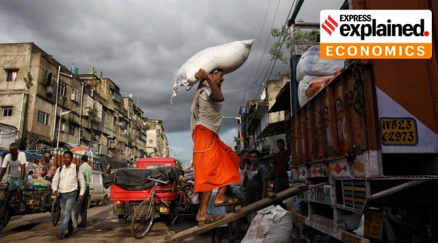 A worker loads sacks into a truck (AP/File)