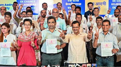 Aam Aadmi Party candidates with Arvind Kejriwal on Tuesday. (Photo: PTI)