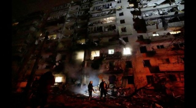 Firefighters work at the site of a damaged residential building, after Russia launched a massive military operation against Ukraine, in Kyiv, Ukraine, February 25, 2022 in this frame grab of a still image use in a video.  (Ukrainian Ministry of Emergencies/via Reuters TV/Handout via REUTERS)