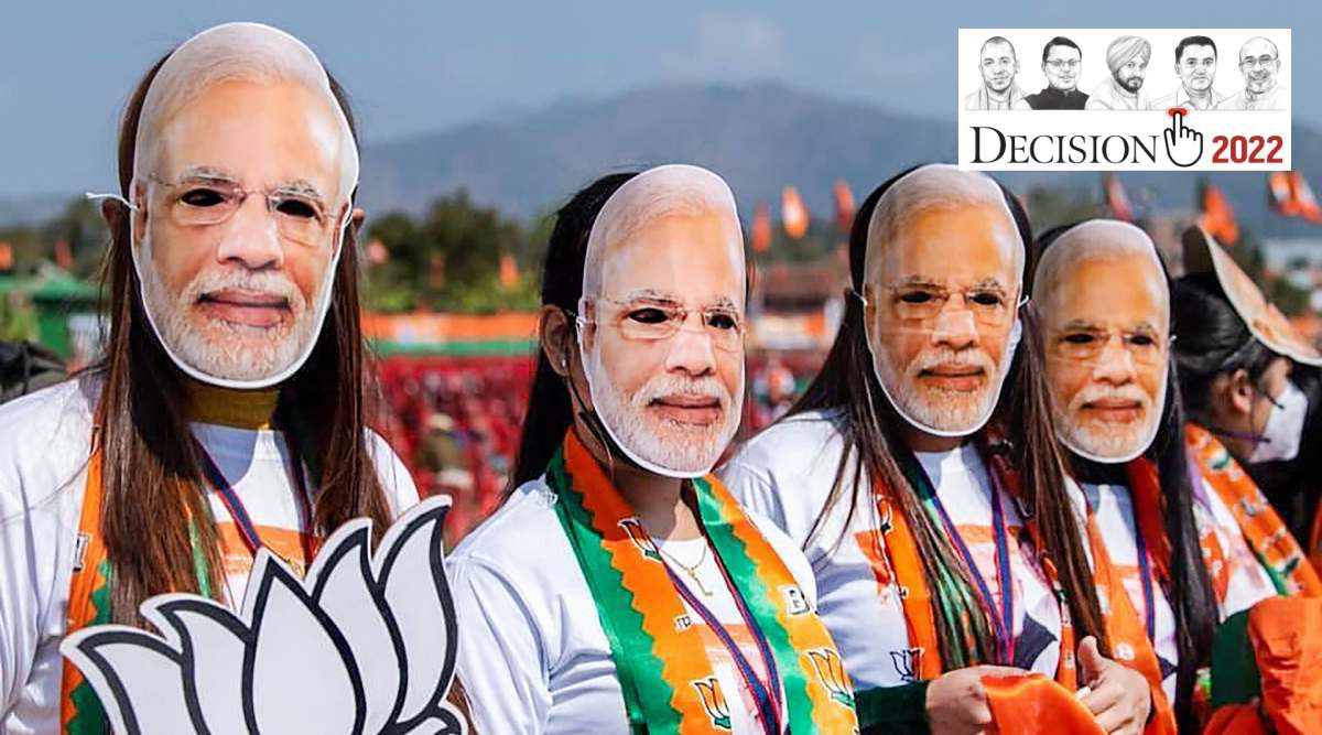 BJP workers wearing masks of Prime Minister Narendra Modi attend his election campaign rally, for the upcoming Manipur Assembly elections at Luwangpokpa Multi-Sports Complex, in Imphal. (PTI Photo)