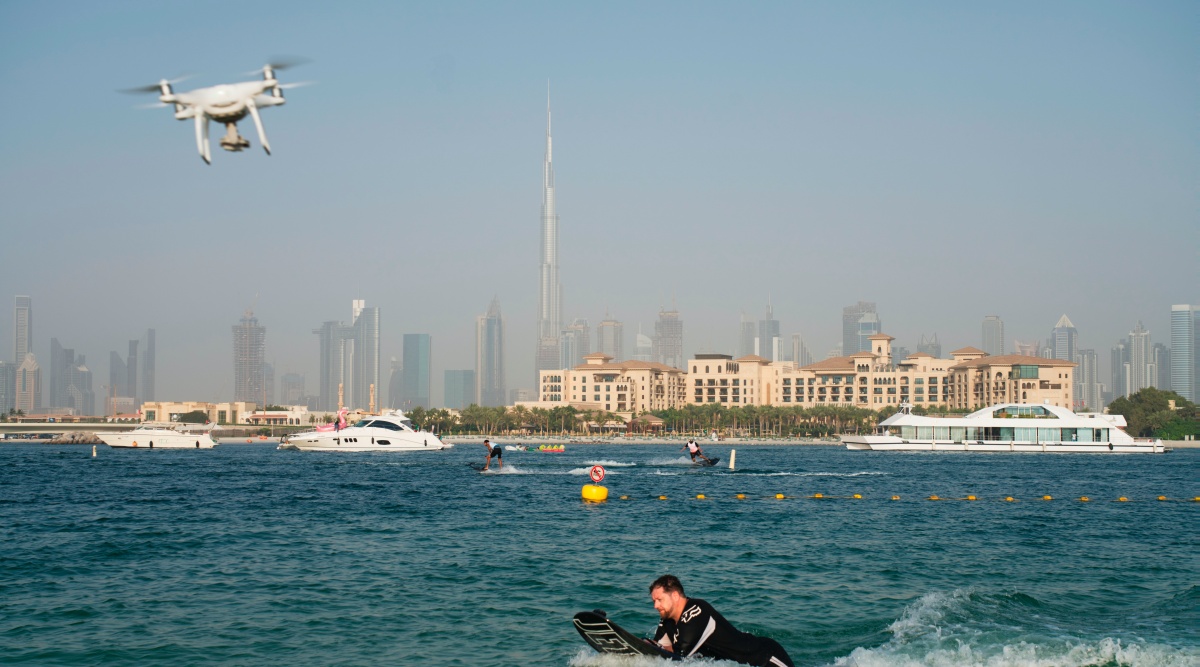 A drone follows a man riding a motorized surfboard in Dubai, United Arab Emirates, June 25, 2020. (AP Photo)