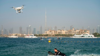 A drone follows a man riding a motorized surfboard in Dubai, United Arab Emirates, June 25, 2020. (AP Photo)