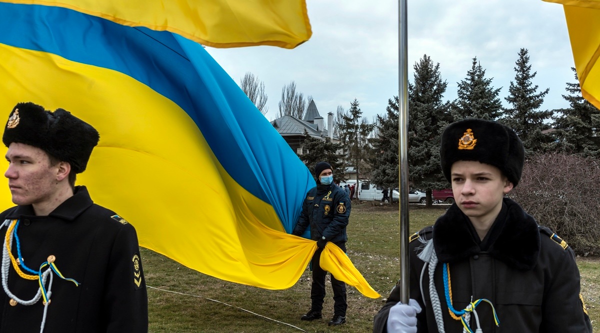Naval cadets from a local maritime academy hold Ukrainian flags during a ceremony to mark Unity Day in Kherson, Ukraine, on February 16, 2022. (Brendan Hoffman/The New York Times)