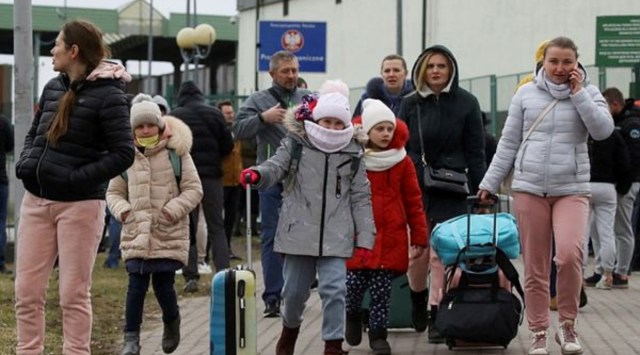 People arrive at the border crossing between Poland and Ukraine, after Russia launched a massive military operation against Ukraine, in Medyka, Poland, February 25, 2022. (Reuters)