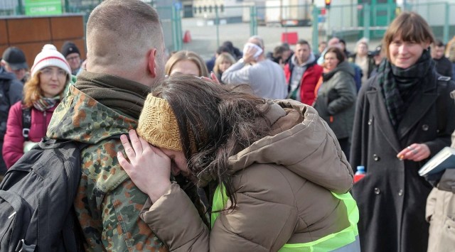 A Polish woman hugs a Polish volunteer named Jedrzej 34, waiting to cross the border to go and fight against Russian forces at Medyka border crossing, in Medyka, Poland, Saturday (AP/Visar Kryeziu)