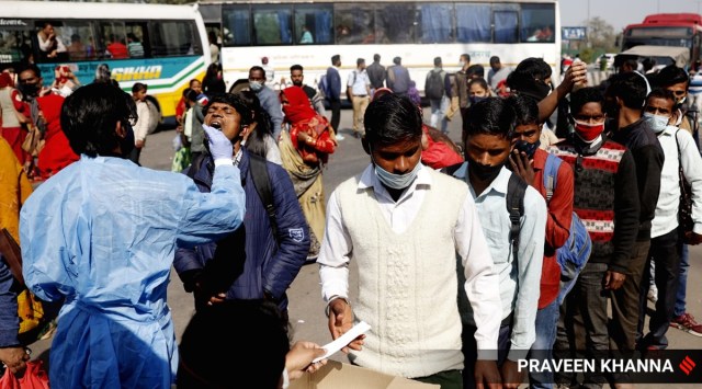 A health worker takes swab sample for Covid test in New Delhi. (Express File Photo by Praveen Khanna)