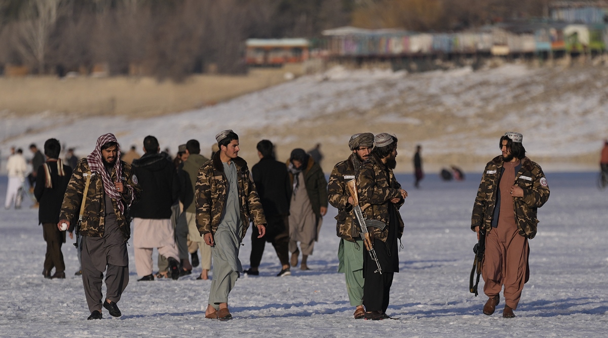 Taliban fighters walk at the frozen Qargha Lake, near Kabul, Afghanistan, in Kabul, Afghanistan, February 11, 2022. (AP)