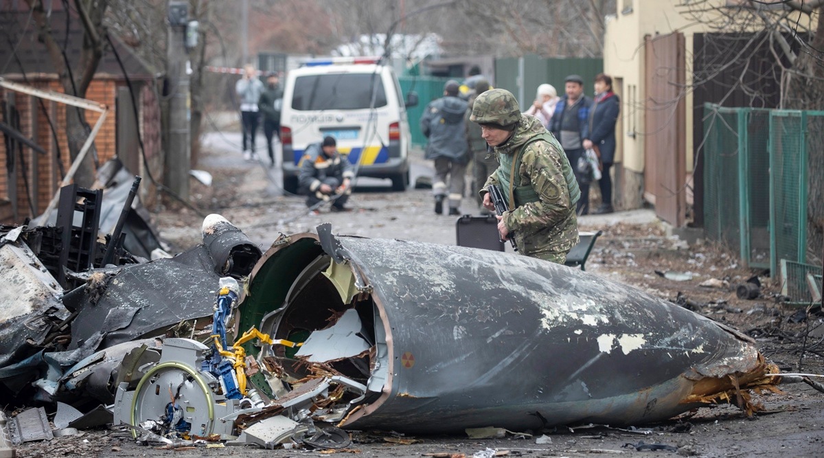 A Ukrainian Army soldier inspects fragments of a downed aircraft in Kyiv, Ukraine, February 25, 2022. (AP)