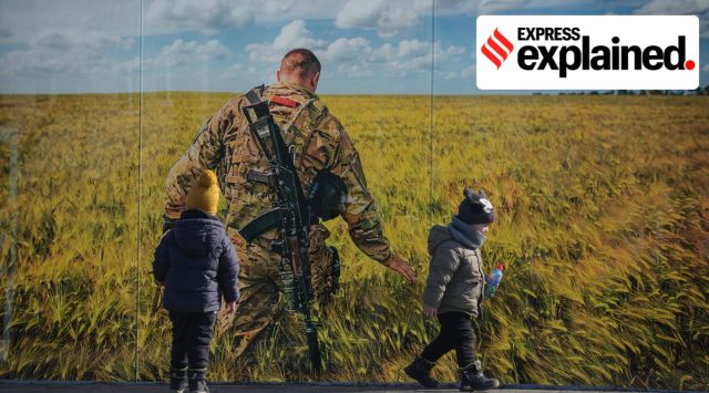 Children play by a large print at a photographic memorial for those killed in the confrontation between Ukraine's military and the pro-Russia separatist forces in Sievierodonetsk, the Luhansk region, eastern Ukraine, Wednesday, Feb. 23, 2022. (AP Photo/Vadim Ghirda)


