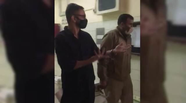 Umar Khalid being brought to court in handcuffs.