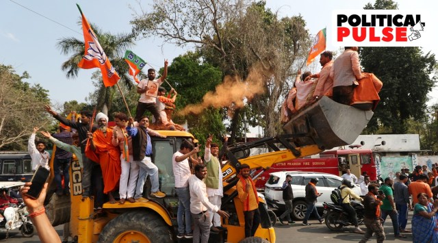BJP workers, atop a bulldozer, celebrate the party’s victory in Lucknow. (Express photo by Vishal Srivatstav)
