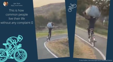 cycling with bundle on head, Anand Mahindra, cycling, hands on head and cycling, cycling video, indian express