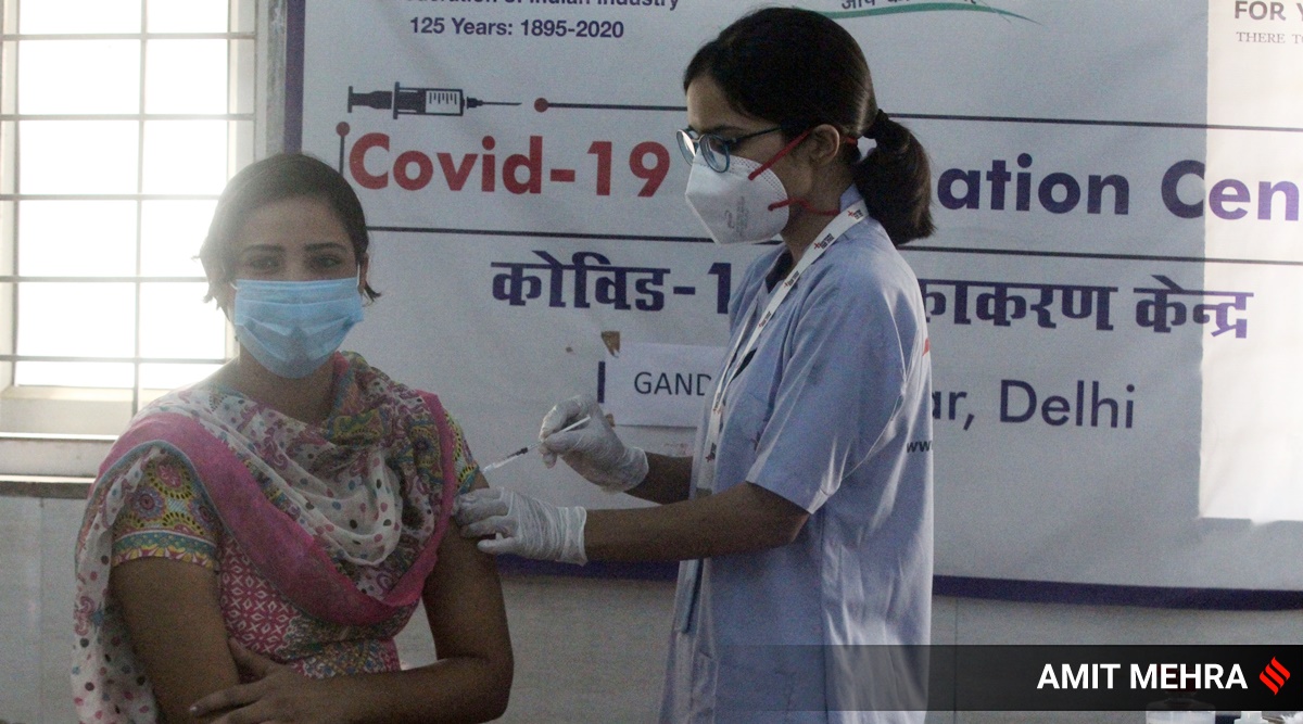 A beneficiary receiving Covid-19 vaccine at a vaccination centre in Delhi. (Express photo by Amit Mehra)
