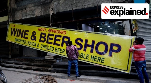 Workers put up the signboard of a liquor shop at Jangpura in New Delhi. (Express Photo/Praveen Khanna)